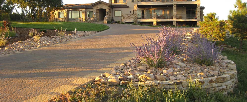 This beautiful paver driveway stands out within this Flying Horse landscape.